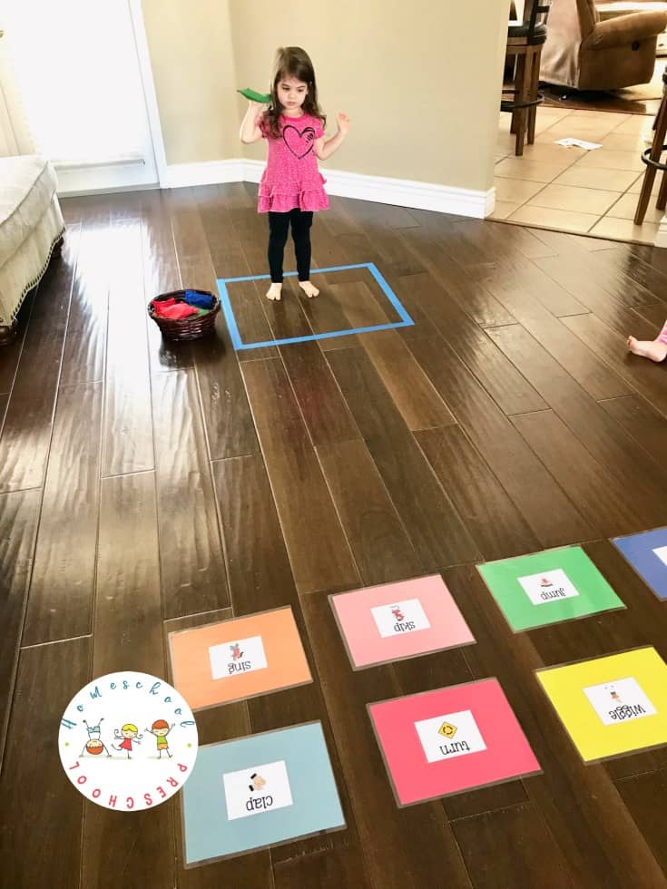 Set up this educational bean bag toss game! It's a great way to help kids learn action words (verbs) and build gross motor skills at the same time.